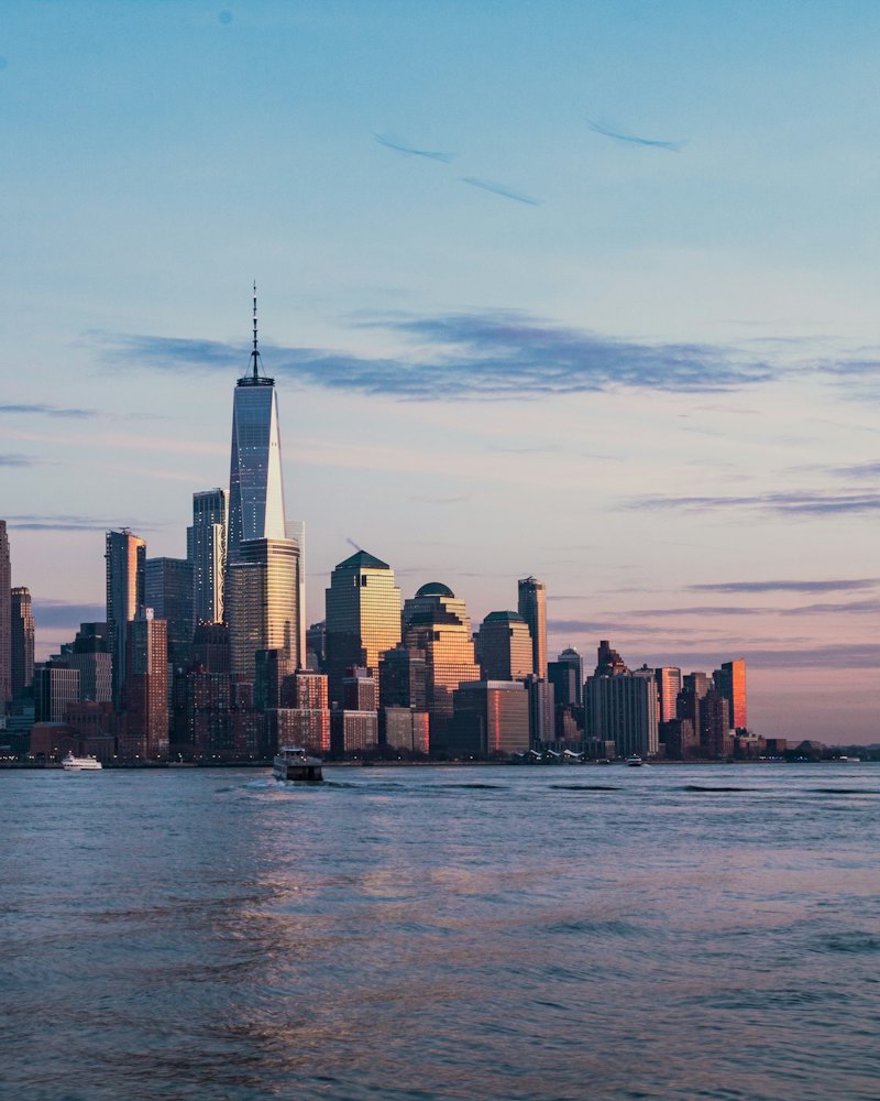 Lower Manhattan skyline across the Hudson River at sunset