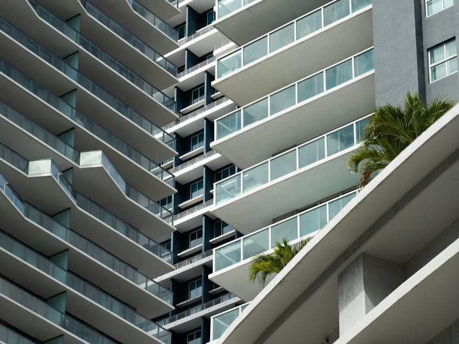 Residential tower with white balconies and palm trees